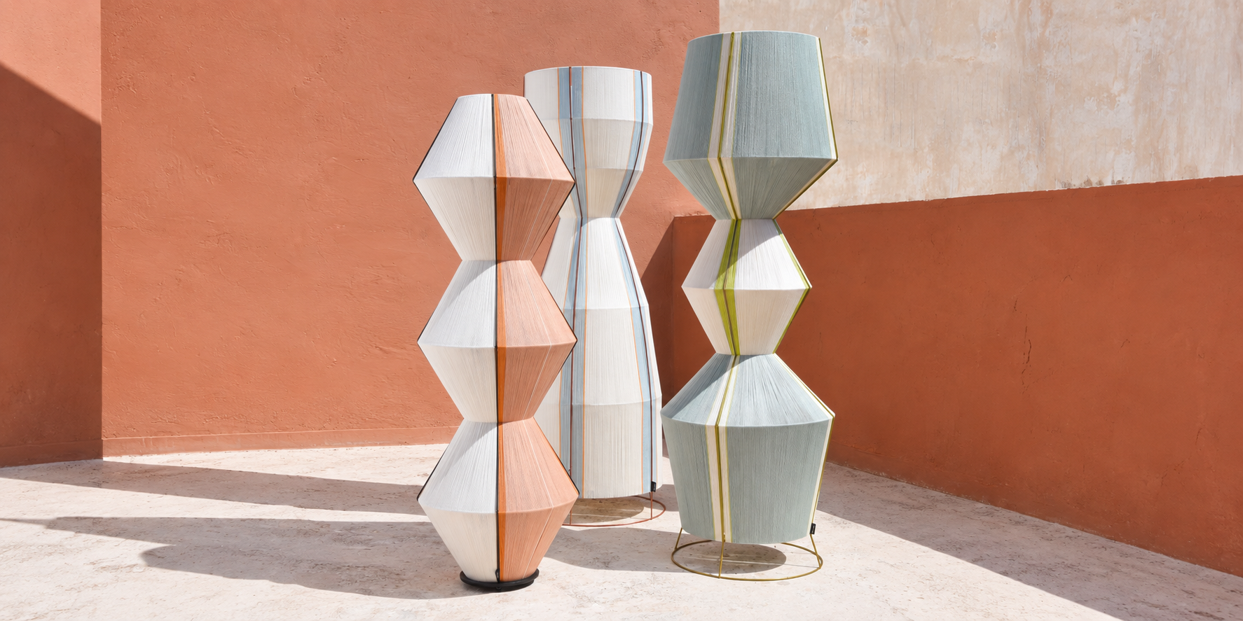 STELE, MORPHE and SYNDESIS sculptural floor lamps from the HOMMETRY SYMMETRIA collection in a sunlit terracotta interior
