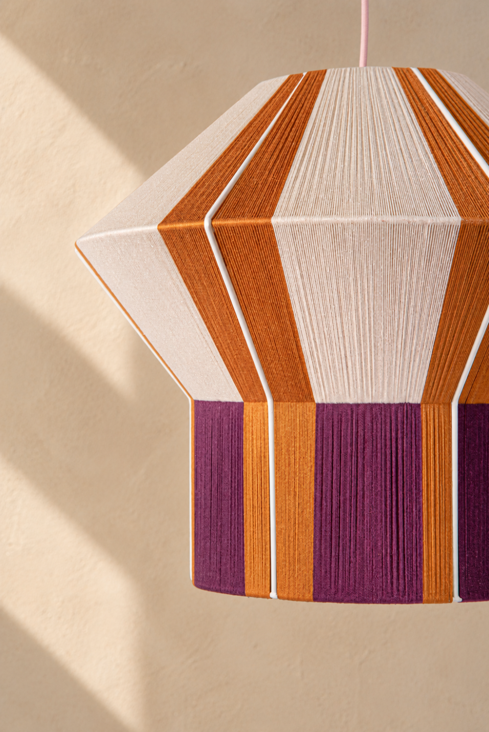 Close-up of the hand-threaded ASTYPALAIA pendant lamp by HOMMETRY in a warm architectural interior